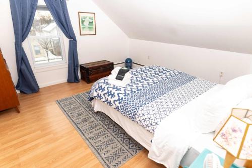 a bedroom with a bed and a window at Centrally Located Winooski Apartment in Winooski