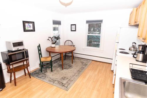 a small kitchen with a table and a kitchen gmaxwell gmaxwell gmaxwell gmaxwell gmaxwell gmaxwell gmaxwell at Centrally Located Winooski Apartment in Winooski