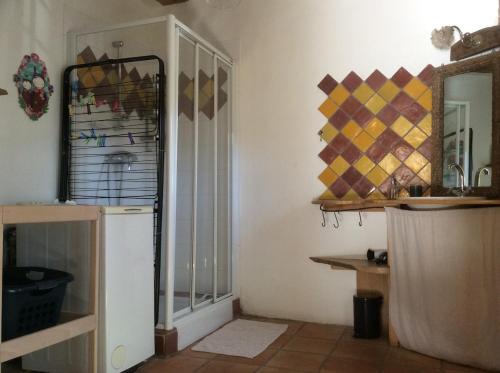 a kitchen with a mirror and a white refrigerator at Le RepAire de La SalAmandre in Ivrey