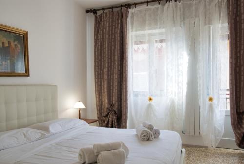 a bedroom with a bed with towels on it at Tana del Manzoni in Barzio