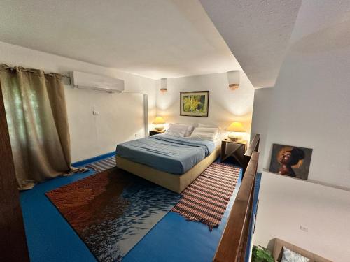 a bedroom with a bed with a blue floor at Amnesia Residence in Naama Bay - Downtown in Sharm El Sheikh