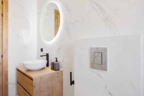 a bathroom with a sink and a mirror at Villa Sa Sirvi in Santa Ponsa
