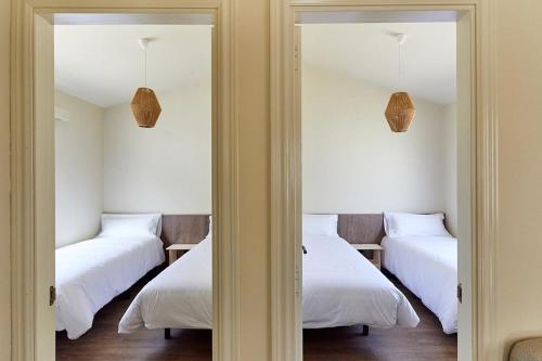 a room with three beds and two mirrors at Camping Taiga Lake Caspe - Maeva Vacansoleil in Caspe