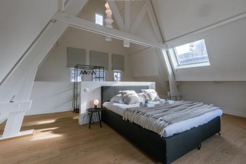 a bedroom with a large bed in a attic at Bright Duplex near Antwerp Cathedral in Antwerp