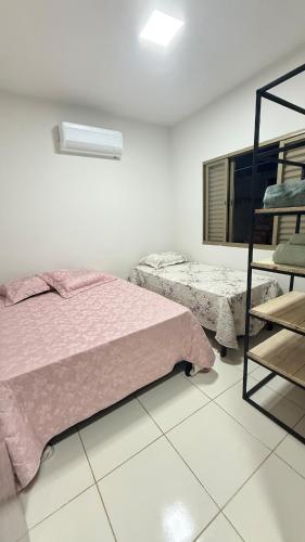 a bedroom with two beds and a ladder in it at Canastra House in Delfinópolis