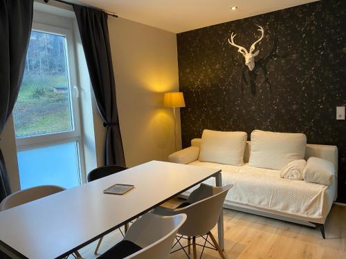 a living room with a white couch and a table at Apartment End in Heidelberg