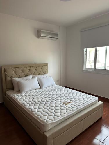 a bedroom with a large bed with white sheets at CityLink-3Bedrooms Appartment CityCenter in Limassol