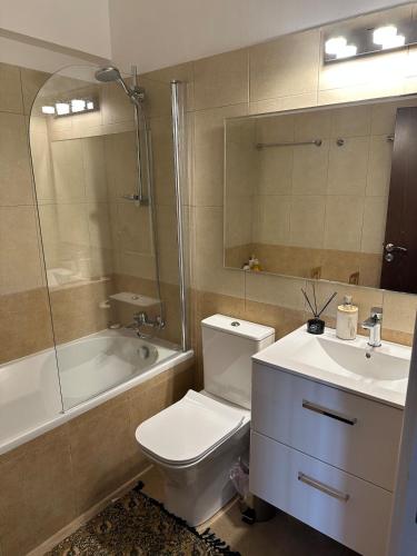 a bathroom with a toilet and a sink and a tub at CityLink-3Bedrooms Appartment CityCenter in Limassol