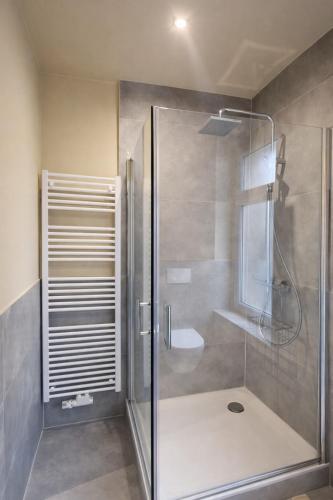 a shower with a glass door in a bathroom at Casa Mateo - Mediterranean Studio in Bielefeld