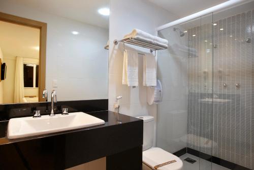 a bathroom with a sink and a toilet and a shower at Majestic Rio Palace Hotel in Rio de Janeiro