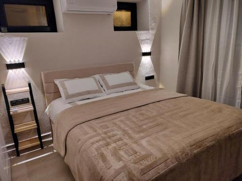 a bedroom with a large bed with two pillows at Baykus Deluxe in Kuşadası
