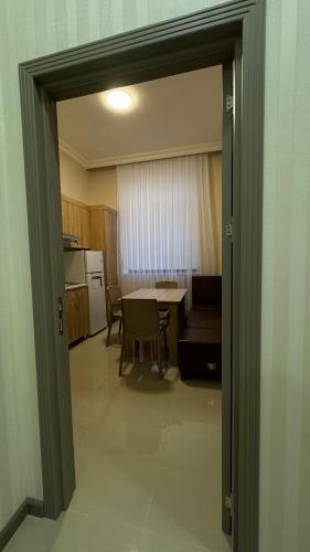 an open door to a kitchen with a table and chairs at RAA apartments in Qusar