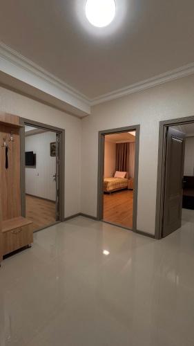a large empty room with a bed in the background at RAA apartments in Qusar