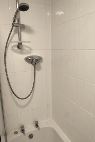a shower with a shower head in a bathroom at Oliver Wests Beautiful 2 Bedroom Sleeps 4 Apartment in Scarborough