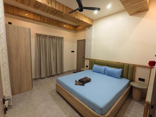 a bedroom with a bed with a stuffed animal on it at Cordial Host in Guwahati