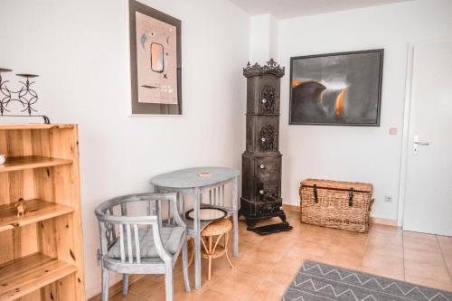 a dining room with a table and a stove at Haffliebe in Ueckermünde