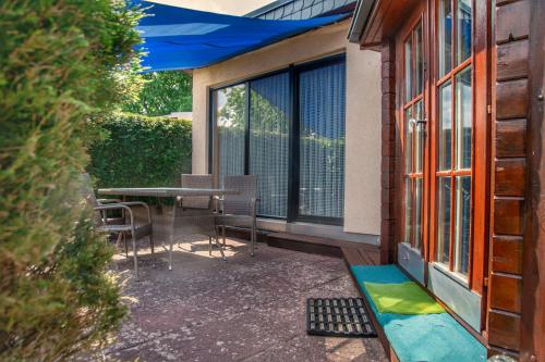 a patio with a table and chairs next to a building at Strandhaus 38 in Mönkebude