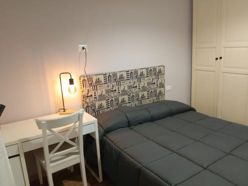 a small bedroom with a bed and a desk at La Casa delle Onde B&B in Pescara