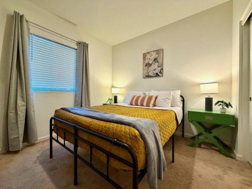a bedroom with a bed and a green table and a window at Attached Guest House in Woodland