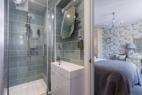 a small bathroom with a sink and a shower at The Mount Pleasant Hotel in Sidmouth