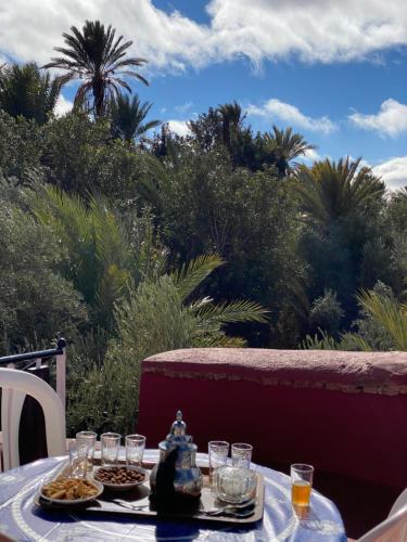 a table with two plates of food and a tea kettle at Auberge sahnoun in Tafraout