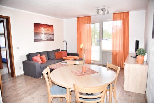 a living room with a table and a couch at Lagunenstadt am Haff - Fewo 4 Muschel in Ueckermünde