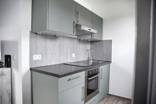 a kitchen with a sink and a stove at Lagunenstadt am Haff - Fewo 181 Kogge in Ueckermünde