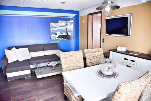 a living room with a table and a couch at Lagunenstadt am Haff - Fewo 72 Flip in Ueckermünde