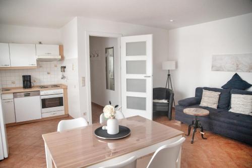 a kitchen and living room with a table and a couch at Lagunenstadt am Haff - 80 Kai in Ueckermünde