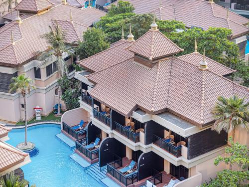 an aerial view of a building with a swimming pool at Livin' Holidays - 1 BR - Anantara Lagoon Stay in Dubai