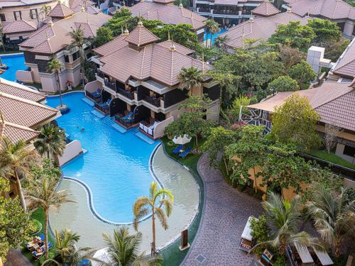 an aerial view of a resort with a swimming pool at Livin' Holidays - 1 BR - Anantara Lagoon Stay in Dubai