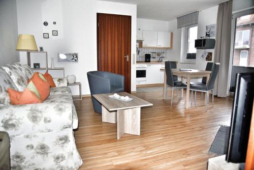 a living room with a couch and a table at Lagunenstadt am Haff - Fewo 125 Yarn in Ueckermünde