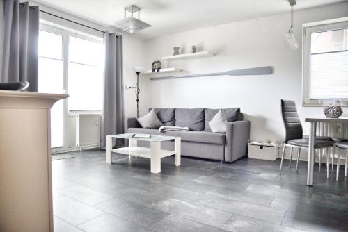 a living room with a couch and a table at Lagunenstadt am Haff - Fewo 34 Palstek in Ueckermünde