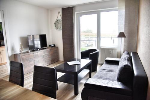 a living room with a couch and a table at Lagunenstadt am Haff - 119 Marina in Ueckermünde