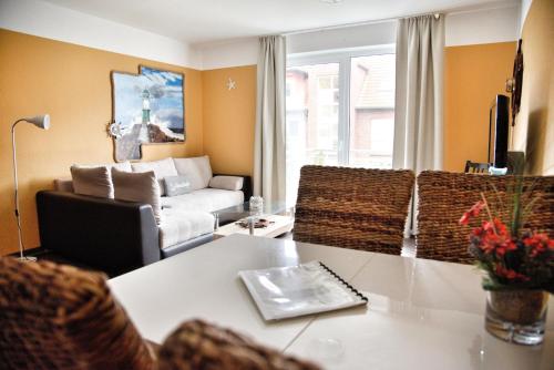 a living room with a couch and a table at Lagunenstadt am Haff - 133 Hol über! in Ueckermünde
