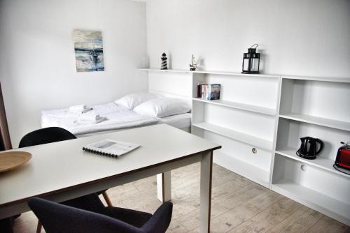 a living room with a table and a couch at Lagunenstadt am Haff - 189 Stromer in Ueckermünde