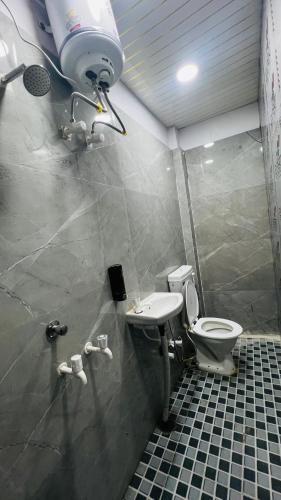 a bathroom with a toilet and a sink at Hotel Stay Inn Lucknow Airport VIP Terminal in Lucknow