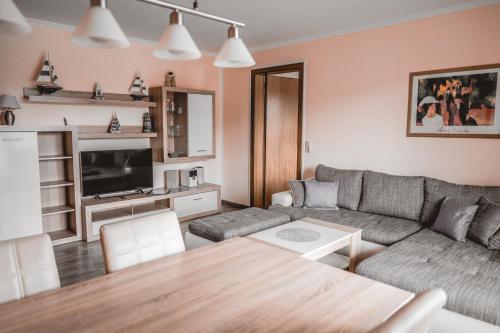 a living room with a couch and a table at Lagunenstadt am Haff - 146 Oberlicht in Ueckermünde