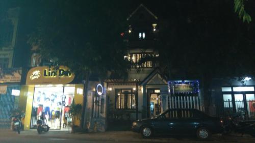 a car parked in front of a store at night at Green CoCo HomeStay in Hoi An