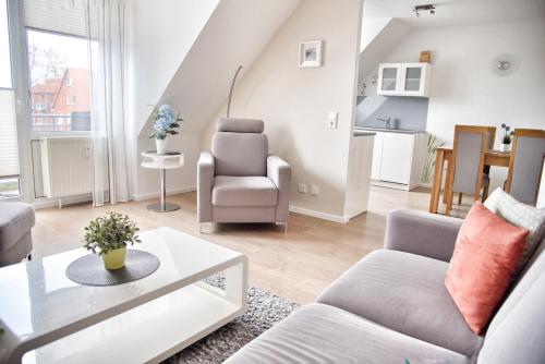 a living room with a couch and a table at Lagunenstadt am Haff - Fewo 161 Arielle in Ueckermünde