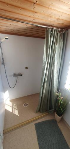 a shower in a room with a shower curtain at Sunset Cabin in Ålesund
