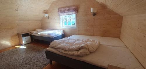 a bedroom with two beds and a window at Sunset Cabin in Ålesund