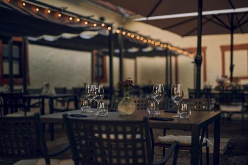 a table with wine glasses and a vase with flowers on it at Camping Terme Catez - Maeva Vacansoleil in Brežice