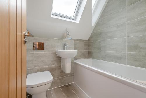 a bathroom with a toilet and a sink and a bath tub at 2 Bed in Bude oc-u31759 in Bude