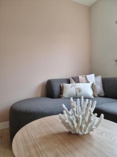 a living room with a couch and a table at LÖYLY Egmond in Egmond aan Zee