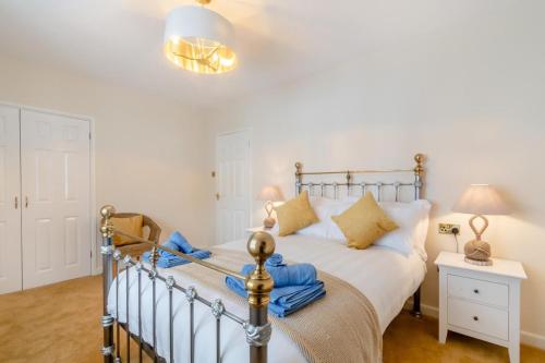 a bedroom with a bed and a table with a lamp at 3 Bed in Tenby oc-m29588 in Tenby
