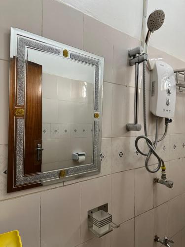 a bathroom with a mirror and a hair dryer at Ekinot homes in Lira