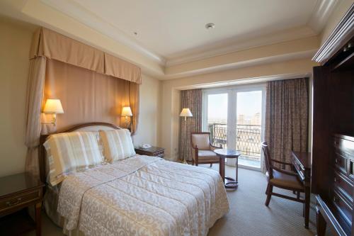 a hotel room with a bed and a balcony at Hotel Grand Tiara Minaminagoya in Anjo