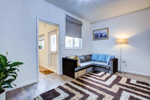 a living room with a couch and a rug at Newly Refurbished 3 Bed 2.5 Bath House in Staines in Staines