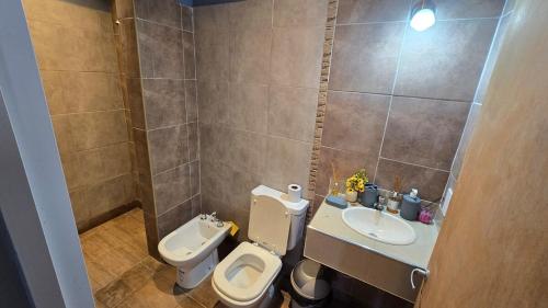 a small bathroom with a toilet and a sink at Casa 12o - Paso de la Patria in Paso de la Patria